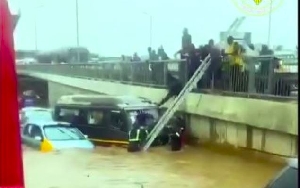 Fire men rescuing stranded passengers during the floods