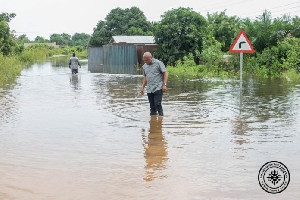 Ablakwa walking in the flood waters in his constituency