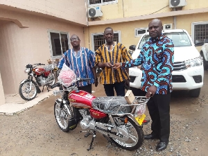 Mr Joshua Nii Bortey presenting the motorcycles to the Assembly members