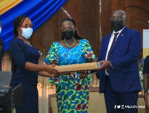 Dr Bawumia presenting a laptop to a student