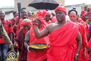 Mantse Ankrah sprinkling Kpoikpoi durring Homowo celebration