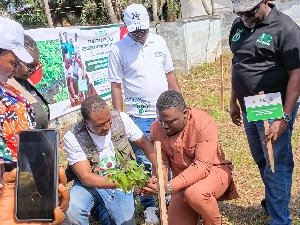 Frank Amoakohene planting a tree