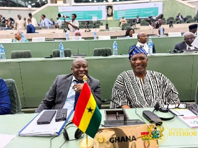 Interior Minister (L) seated with Ghana 's ambassador to Nigeria