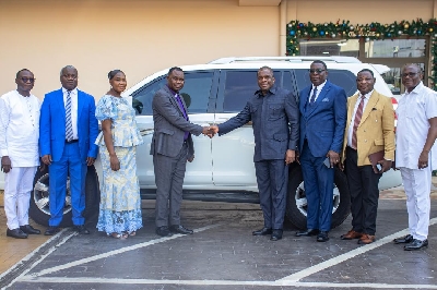 Rew Wengam  presenting the vehicle to Rev. Moses Nasimong