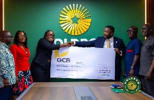 Mr. Richard Nunekpeku presenting the dummy cheque to Obobia Darko Opoku