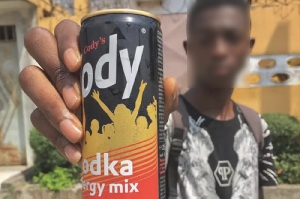 Teen holding an energy drink that has alcohol