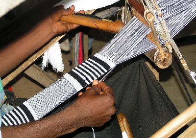 Man weaving kente