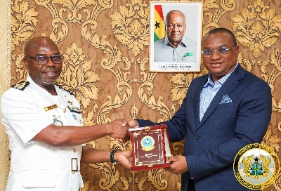Ernest Brogya Genfi presenting a plague  to the leader of the team
