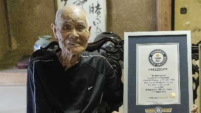 Hiro Komae/AP (Pic): Kokichi Akuzawa poses for a photo with his certificate in Maebashi, northeast of Tokyo, on September 3, 2025