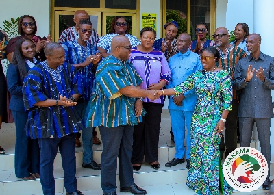 Dr Victor Bmapoe presenting the cheque Adwoa Oboubia Darko Opoku in Accra