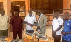 Kumawu MP presenting the items to the DCE