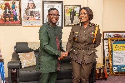 MCE in a hand shake with officials from Ghana Prisons Service