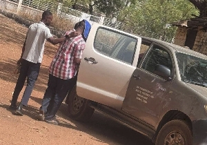 Abdallah Mohammed being ushered into a car