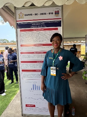 Dr Ewura Adjoa Ahimah Nunoo standing by a summerised edition of her research on hypertension presented at the Scientific Conference 2025