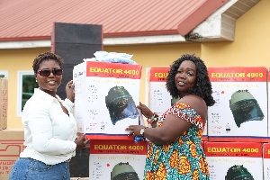 Dorcas Affo -Toffey presenting  item to a beneficiary