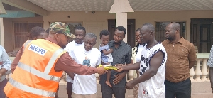 Oforikrom NDC members presenting the cash to father of the sick boy