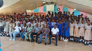 Members of the NGO and NCCE in a group photograpgh with the school children