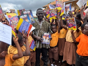 MP distributing the books to the pupils in Ahafo Ano