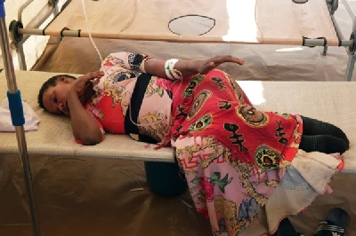 Cholera patient lying on a sick bed