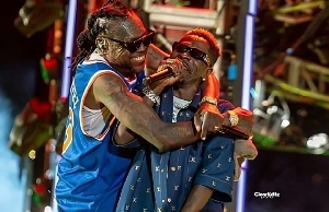 Vybz Kartel fondly hugs Shatta Wale during the Freedom Street Concert 2024 in Jamaica