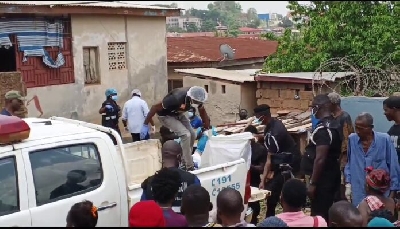 The  body of Junior being conveyed by the police to the morgue