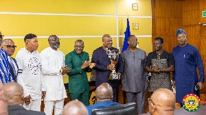Speaker presenting the cup to  the President