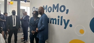Shatta Wale and Shaibu Haruna pose for a picture at the latter's Mobile Money Ghana office
