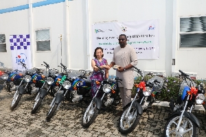 Official of JICA presenting the motobikes to John Dumelo