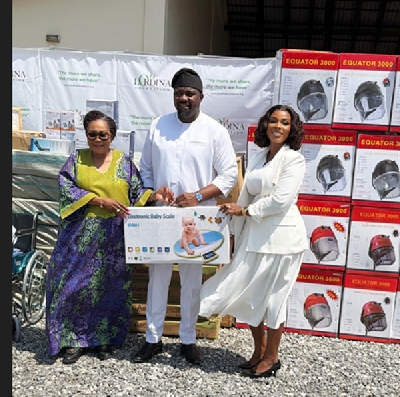 Lordina Mahama presenting the medical supplies to John Dumelo