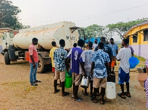 Water tnaker supplying water to students