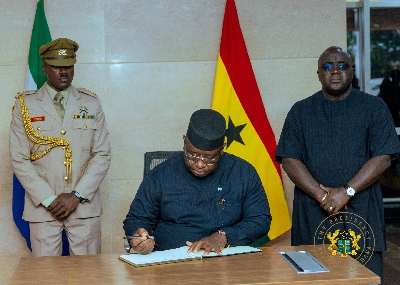 President of Sierra Leone, Julius Maada Bio signing the book of condolence