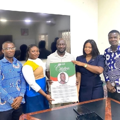 Accra City cmapus TEIN presenting a plague to Okai Mintah