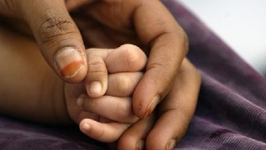Hands of mother and baby