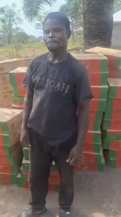 AI-improved screenshot of taxi driver with boxes of tin tomatoes behind him