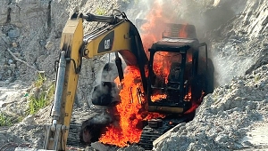 Seized excavator being burnt