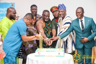 Minister and stakeholders cutting a cake to mark the day in Accra