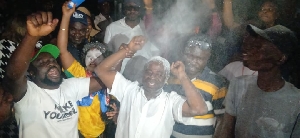 Kingsley Atta in white, with powder on his head